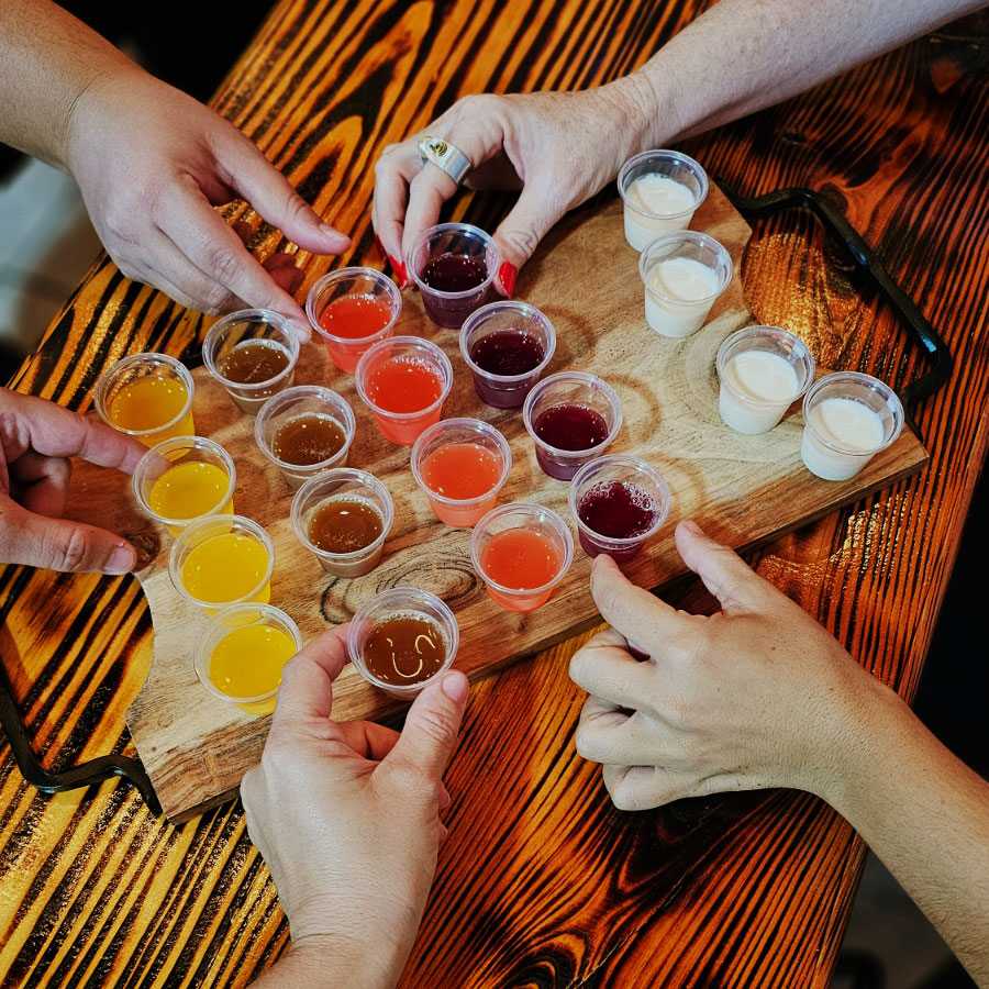 a picture of people taking sangria shot glasses